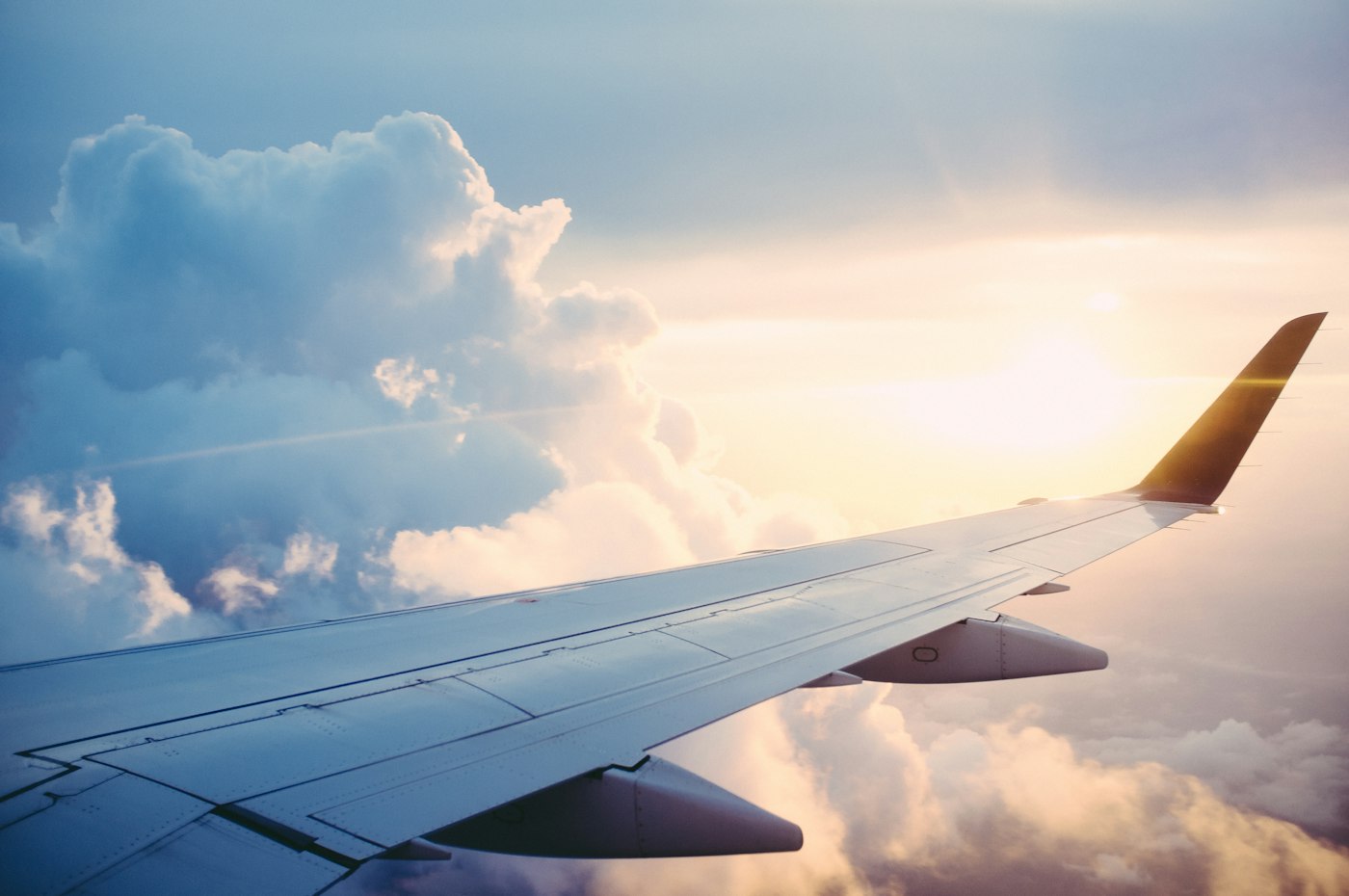 Airplane taking off at sunset over airport runway